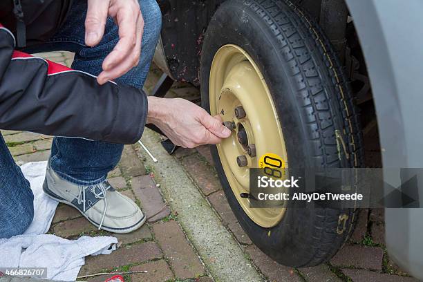 Dutch Man Changes A Wheel Because Of Flat Tyre Stock Photo - Download Image Now - Auto Mechanic, Broken, Car