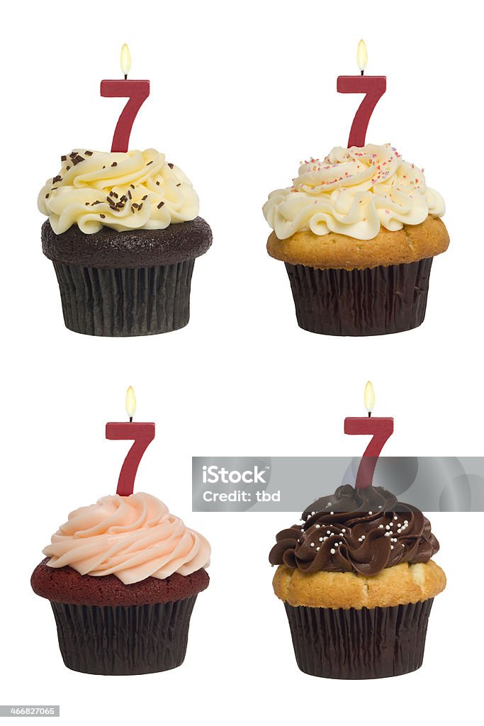 Numbered Cupcake Four different cupcakes: vanilla-chocolate, vanilla-vanilla, red-velvet and chocolate-vanilla. Each has a lit number 7 candle (see the "more cupcakes" link below to see  the rest of this series, featuring all single digit numbers). Shot against a pure white background. Anniversary Stock Photo