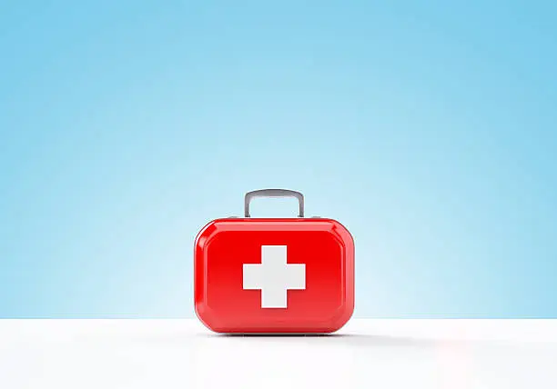 First aid kit on blue background with copy space