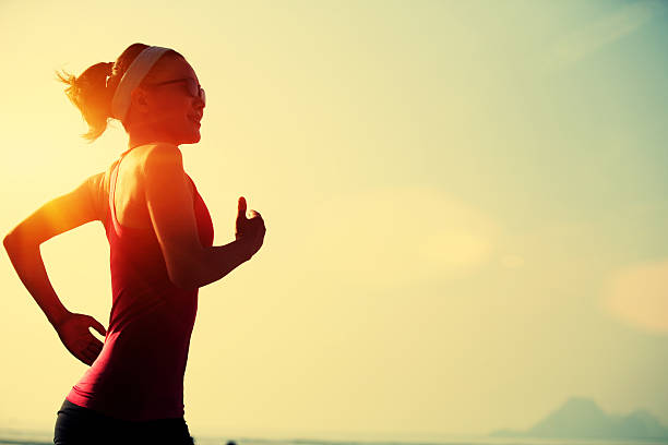 istock young  woman running on  beach 466829654