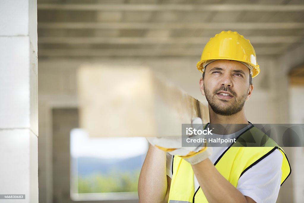 Construction workers Construction worker is working on new house Adult Stock Photo