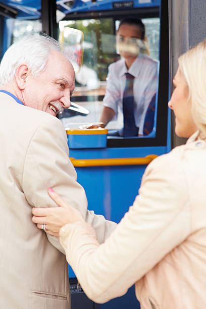 istock Woman Helping Senior Man To Board Bus 466831241