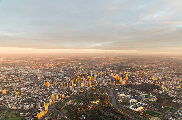 Aerial view of Melbourne CBD 15 September 2013 - aerial view of Melbourne central business district and inner suburbs, at dawn from a hot air balloon, showing the Royal Botanic Garden, Melbourne Cricket Ground, Yarra River and Melbourne skyline. melbourne australia stock pictures, royalty-free photos & images