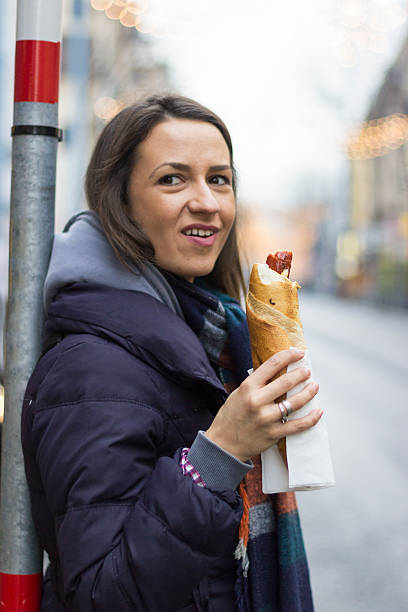 istock girl eating hotdog 466831513