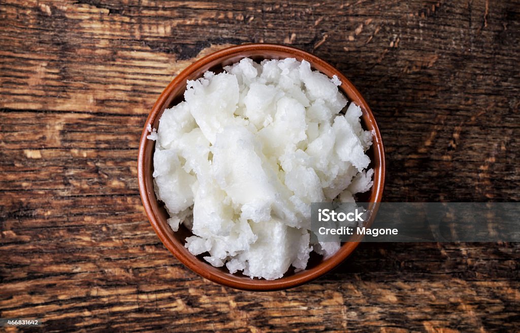 bowl of coconut oil bowl of coconut oil on wooden table, top view 2015 Stock Photo