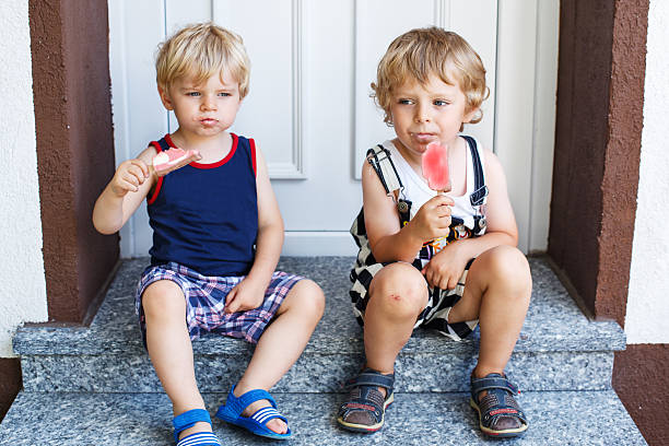 istock Two little twins boys eating ice cream 466832213