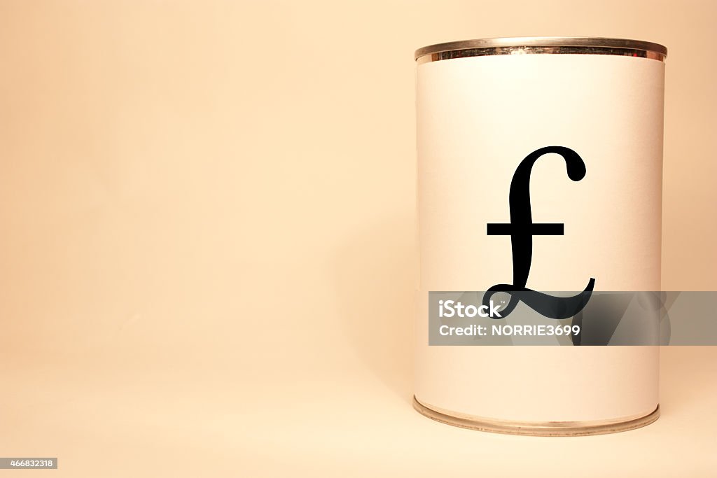 Cost of Hunger An unbranded can/tin of food, labelled with a British Pounds Sterling symbol. 2015 Stock Photo