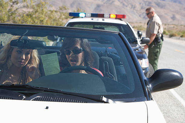 istock Two young women reading speeding ticket in car 466836118
