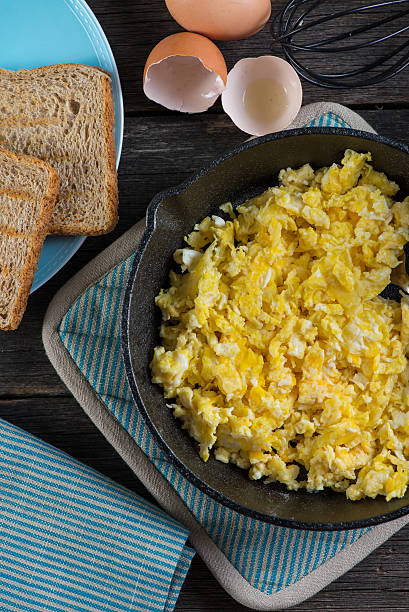 istock scrambled egg with grilled tomato in vintage iron pan 466836656