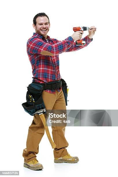 Smiling Carpenter Working With Drill Stock Photo - Download Image Now - Drill, Holding, Men