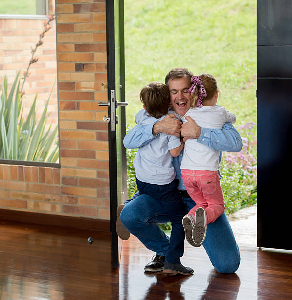 istock Father arriving home and hugging his kids 466837686