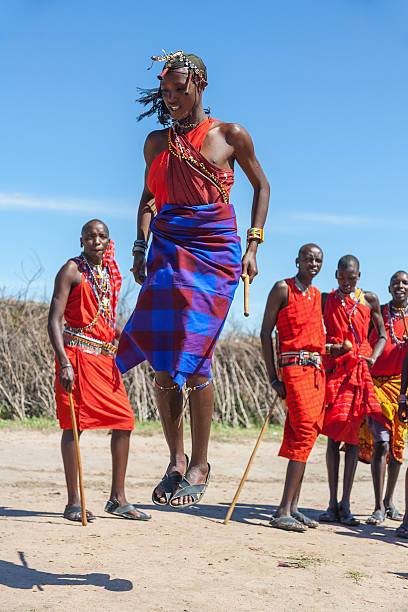 Masai Mara, Kenya - February 12, 2010 : Masai warriors dancing traditional jumps as cultural ceremony,review of daily life of local people,near to Masai Mara National Park Reserve, Feb 12, 2010,Kenya