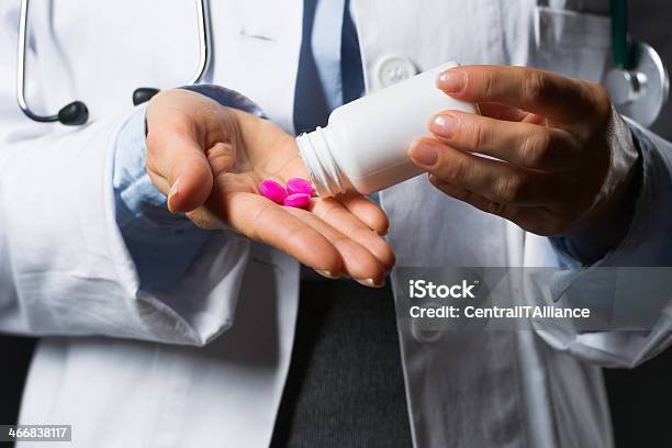 Closeup On Medical Doctor Woman Empty Medicine Bottle In Hand Stock Photo - Download Image Now
