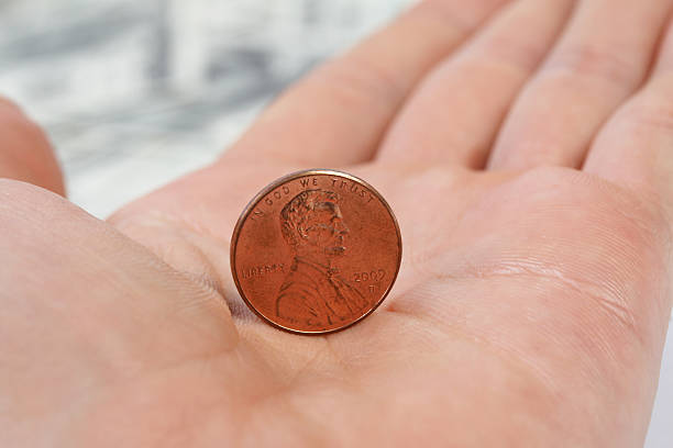 istock Detailed view standing penny on male hand 466839933