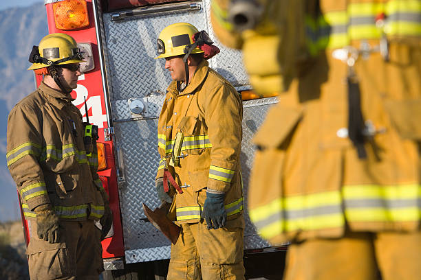 istock Two firefighters standing in front of fire truck 466842258