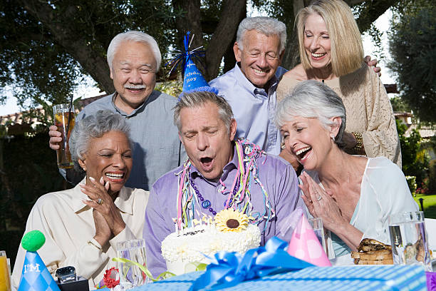Senior couples celebrating birthday party in garden
