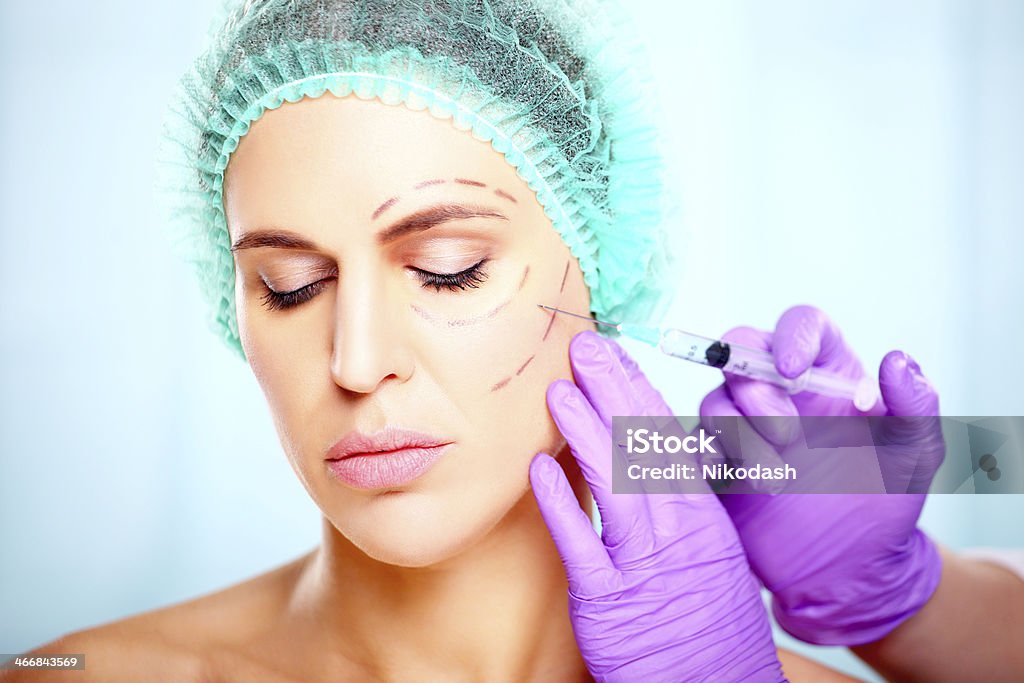 Woman with syringe treatment with botox or hyaluronic, collagen,HA injection Adult Stock Photo