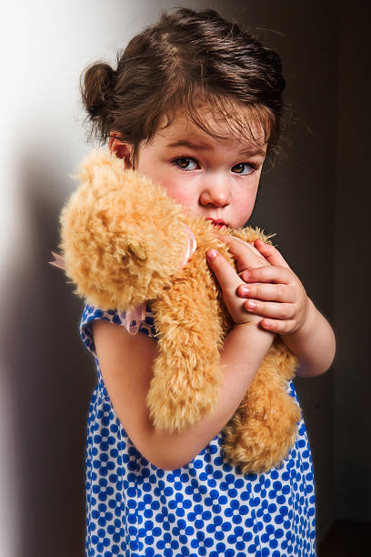 istock Cute little girl hugging teddy bear 466843666