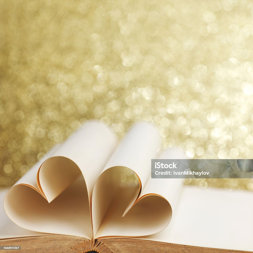 Heart inside a book Heart made of blank pages inside a book on glitter background Blank Stock Photo