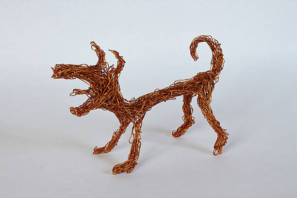 dog made of copper wire on a light gray background