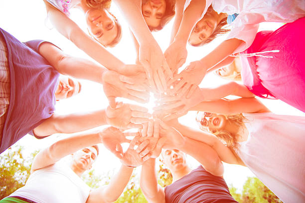 istock Group of people standing in a circle with hands together 466846836