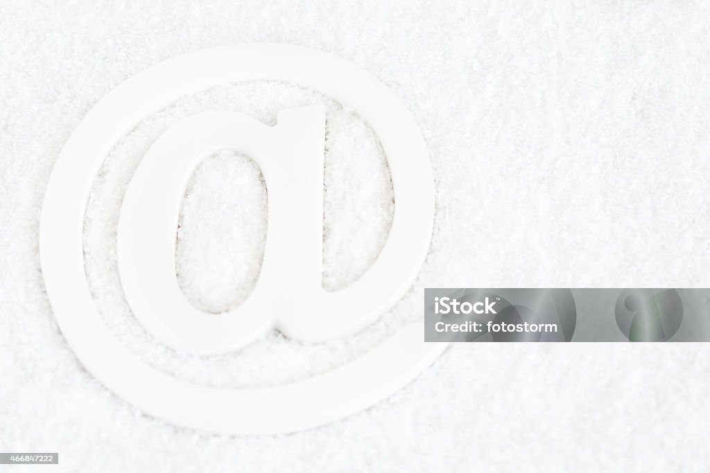 Wooden E-mail 'at' Symbol Wooden e-mail or 'at' symbol on snow. 'at' Symbol Stock Photo