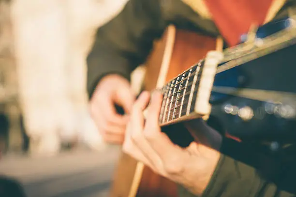 Photo of Close-up of a guitar player with a blurred background