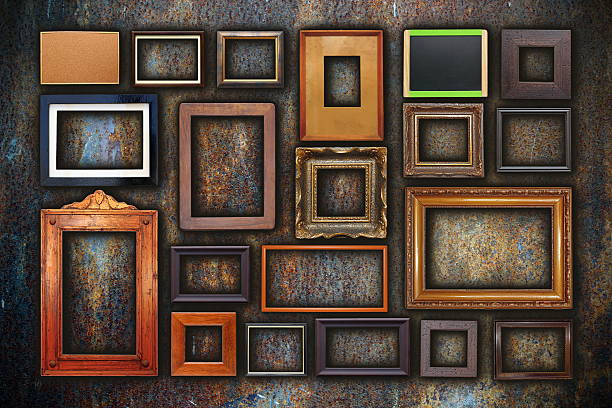 grunge wall full of old frames stock photo