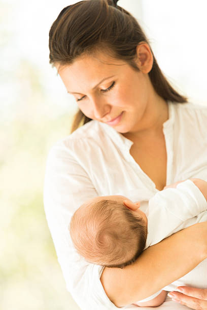 istock Baby sleeping in mother's arms 466851604