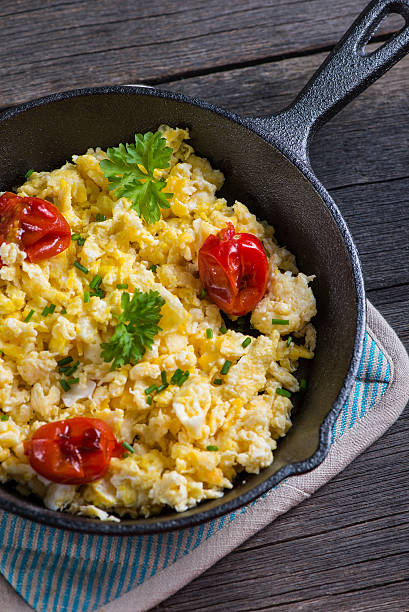 istock scrambled egg with grilled tomato in vintage iron pan 466852712