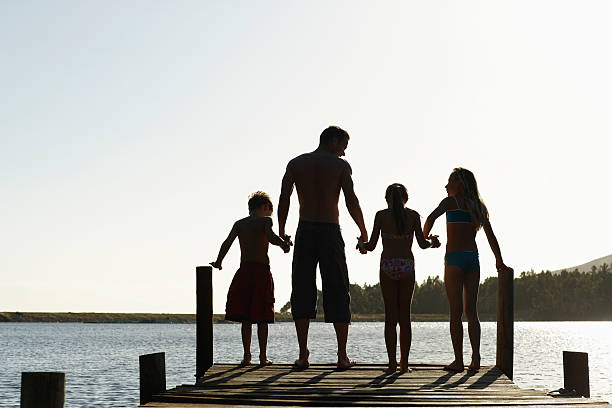 istock Family Standing On Edge Of Jetty 466853008