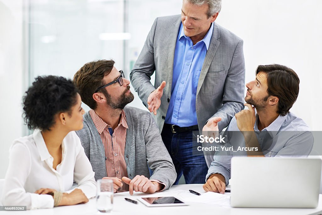 Leading his team through the creative process Shot of a group of a diverse group of business professionals having a meetinghttp://195.154.178.81/DATA/istock_collage/0/shoots/782754.jpg 2015 Stock Photo