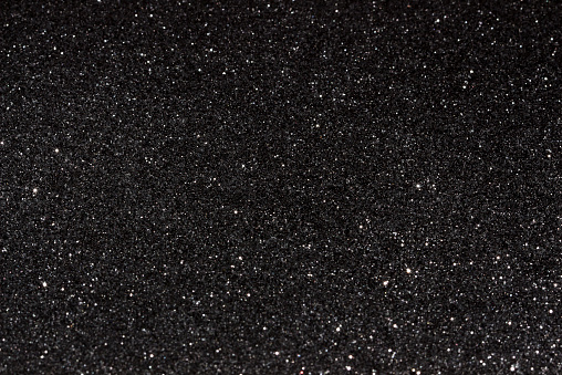 Black glitter texture dark background