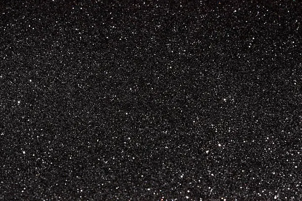Black glitter texture dark background