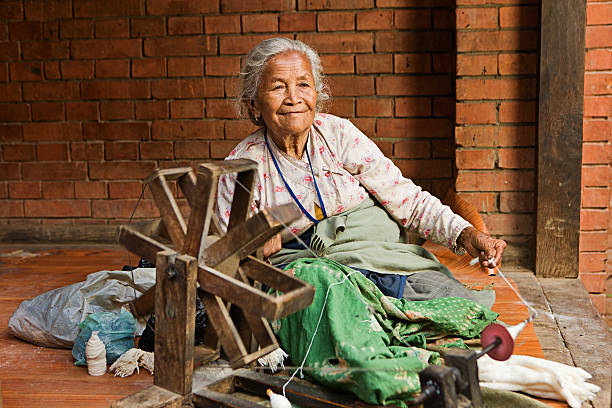 istock Nepali woman spinning the wool. Bhaktapur 466855263