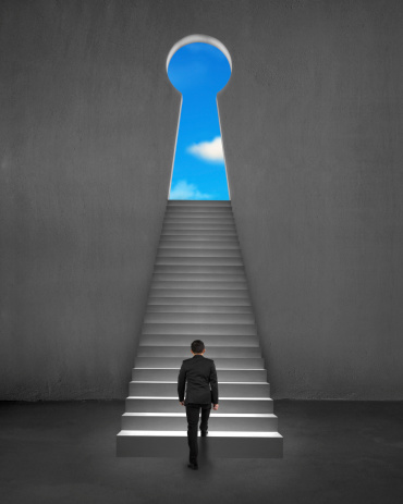 Businessman climbing on stair to key shape door with cloud and blue sky outside