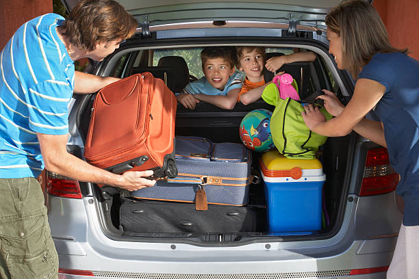istock Couple Loading Luggage Into Car Trunk 466859846