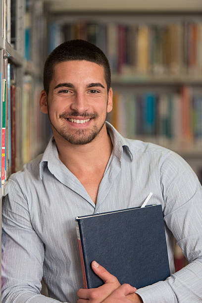 istock Male College Student In A Library 466860222