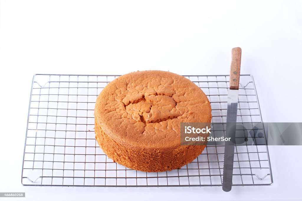 baked chiffon cake on cooling rack baked chiffon cake on a cooling rack with knife 2015 Stock Photo