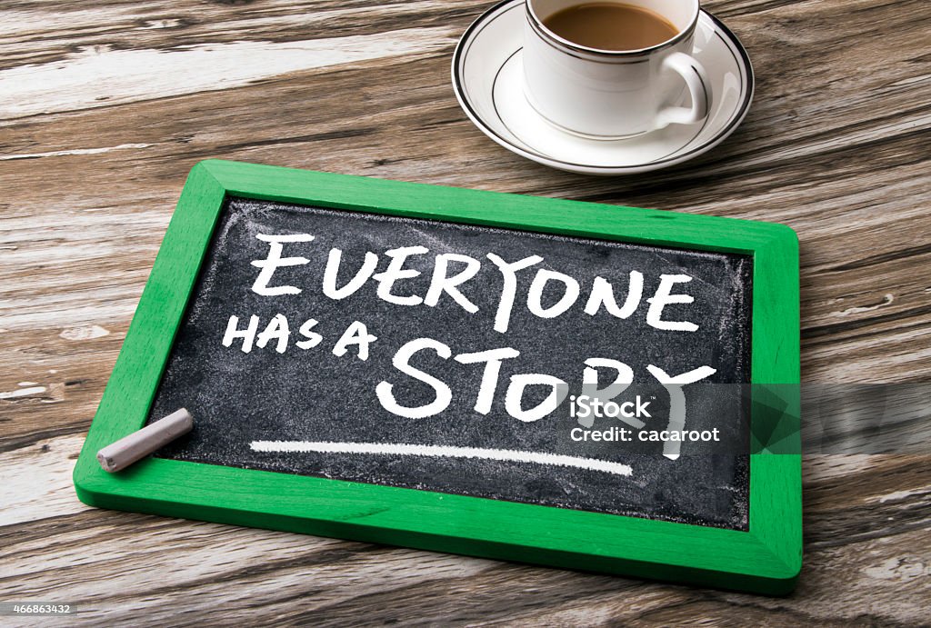 Coffee and chalkboard that says everyone has a story everyone has a story on blackboard 2015 Stock Photo