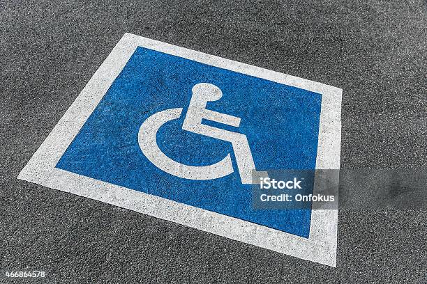 Handicapped Blue And White Parking Sign In Parking Lot Stock Photo - Download Image Now