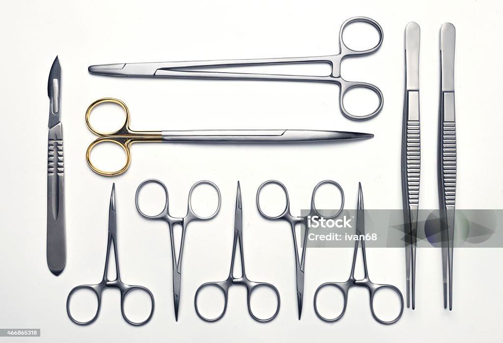 Neatly arranged surgical instruments Numerous surgical instruments neatly arranged on a white background Arranging Stock Photo