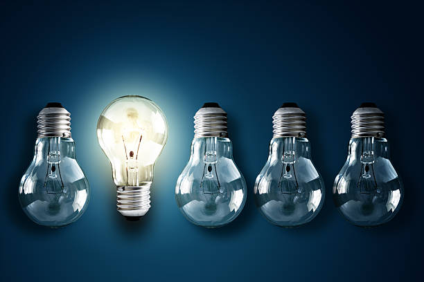 Creativity and innovation Illuminated light bulb in a row of dim ones concept for creativity, innovation and solution tungsten image stock pictures, royalty-free photos & images