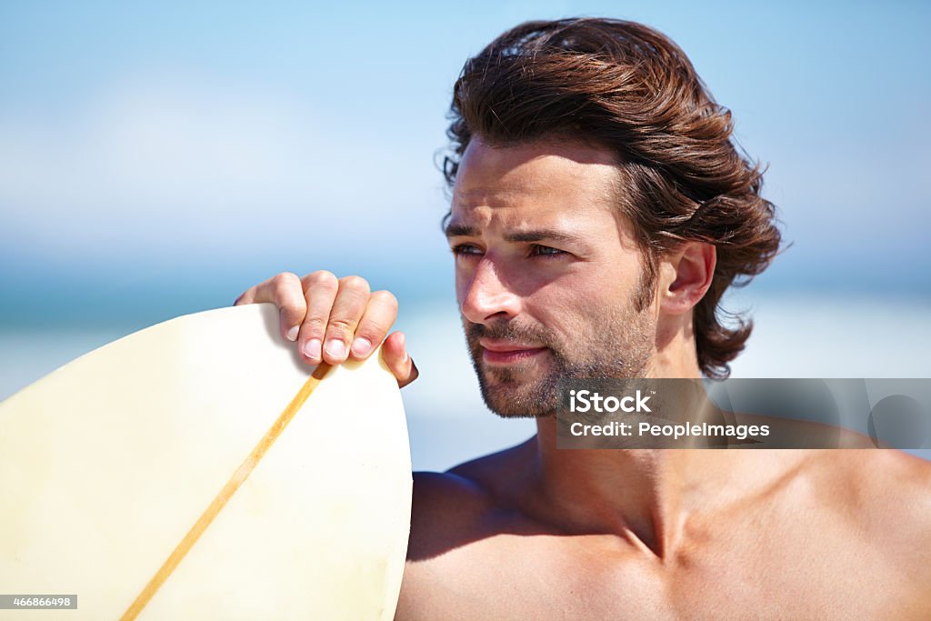 Heading to the water An attractive young man about to go surfinghttp://195.154.178.81/DATA/istock_collage/0/shoots/785334.jpg Men Stock Photo