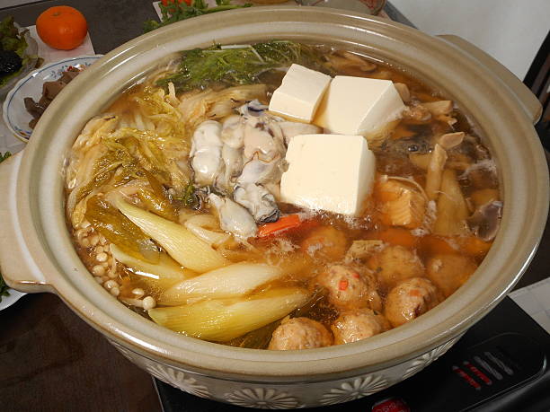 istock Oysters and vegetables boiled and served in a pot 466867506