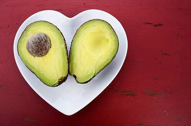 istock Cut in half avocado arranged in heart shaped plate 466867934
