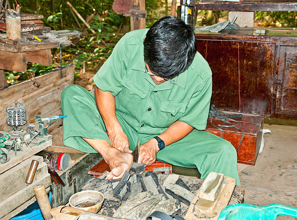 Unidentified vietnamese makes shoes from old truck tires Сu Сhi, Vietnam - November 17, 2013: Unidentified man makes shoes from old truck tires on November 17,2013 in Cu Chi, Vietnam.Cu Chi tunnels were the Viet Cong's base of operations for Tet Offensive. special forces vietnam stock pictures, royalty-free photos & images