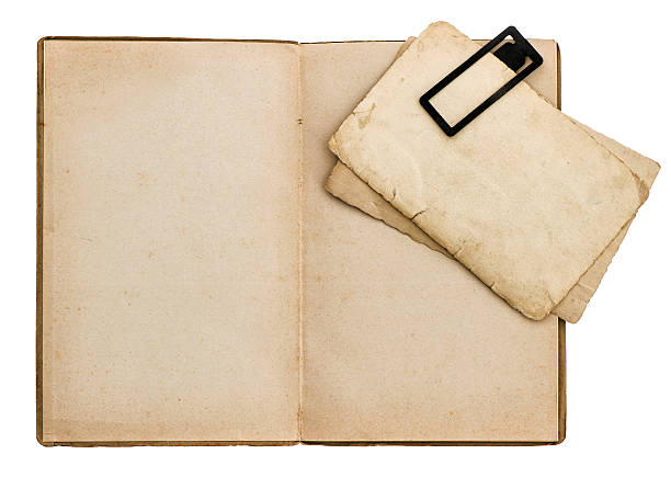 istock Open old book with cardboard and clip isolated on white 466871994