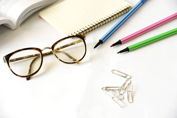 istock Notebook with glasses and pen on table, close up 466872714