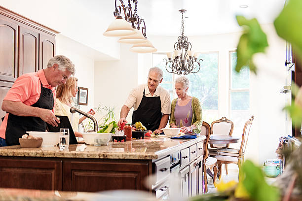 istock Senior people having fun in the kitchen 466873186